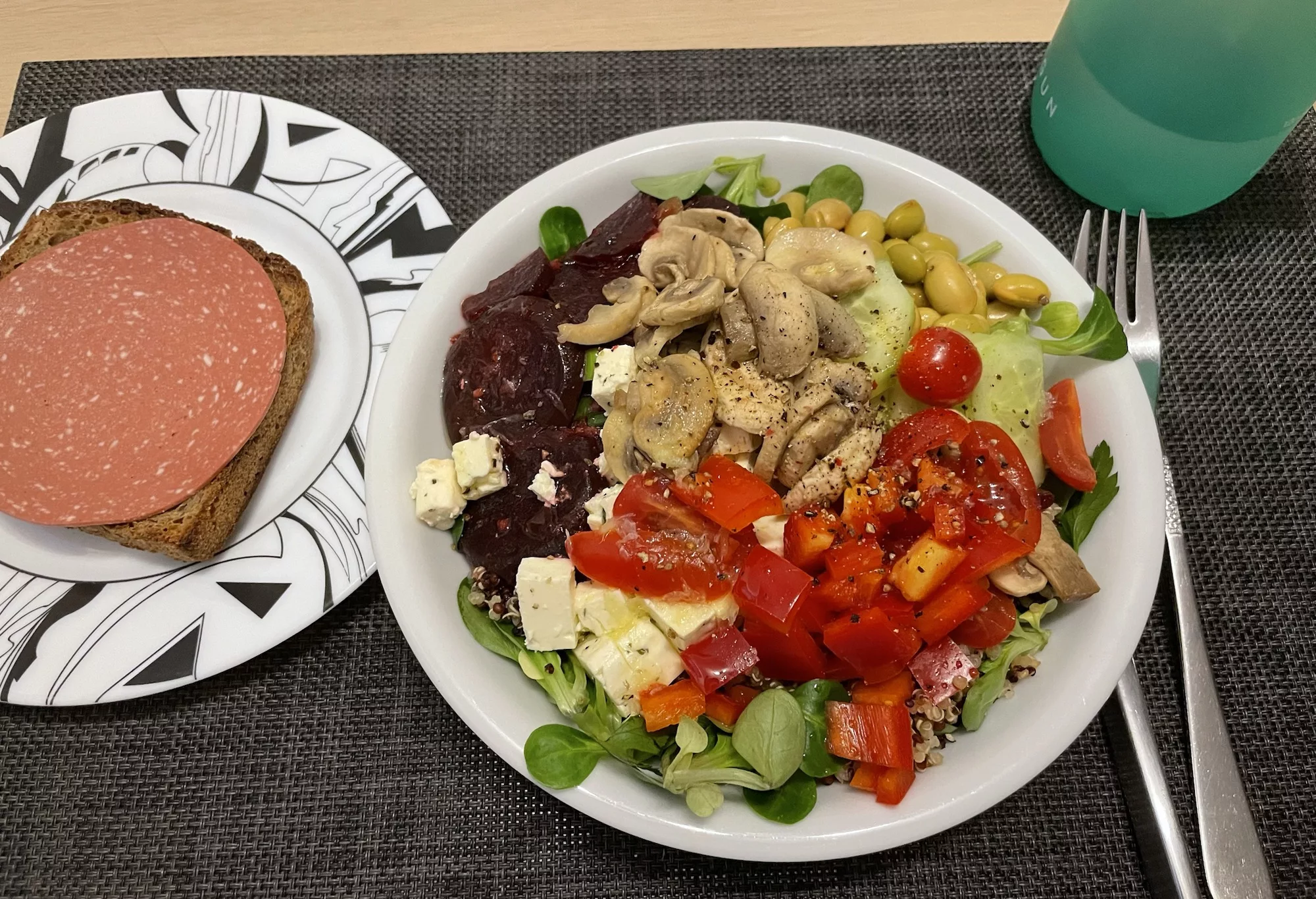 Vegetarischer (wegen Schafskäse) Salat und ein veganes Salamibrot.