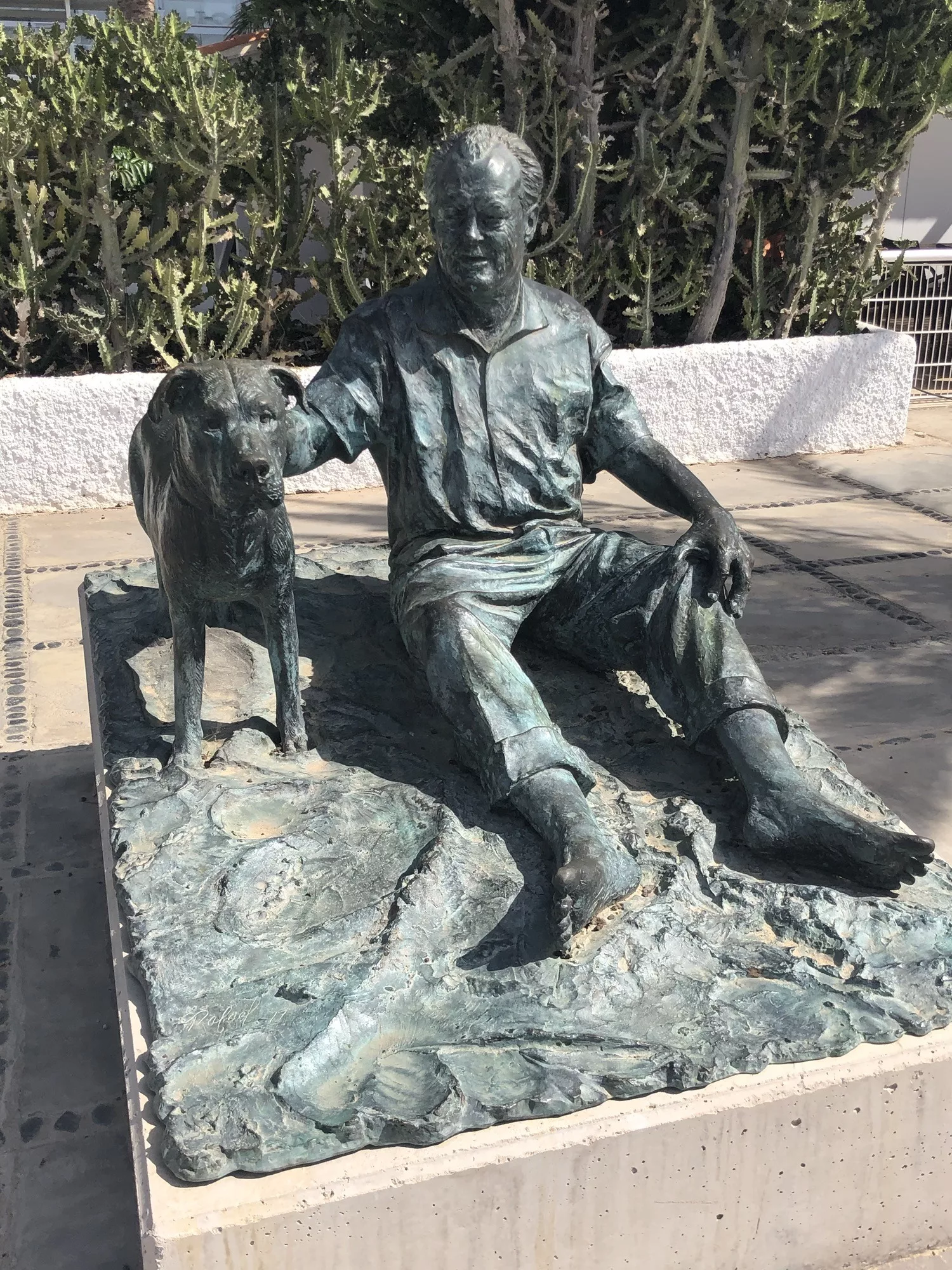 Willy Brand Skulptur sitzen mit Hund am Strand von Jandia.