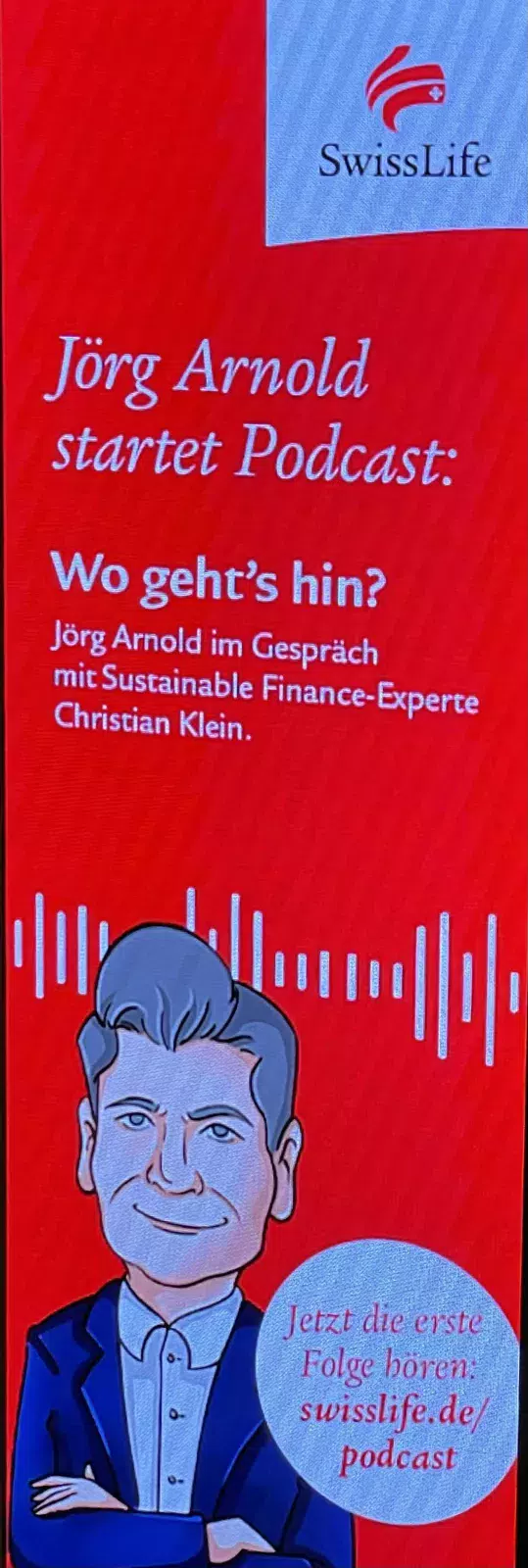 Roter Swiss Life Videoaufsteller mit Ankündigung vom Podcast von Jörg Arnold.