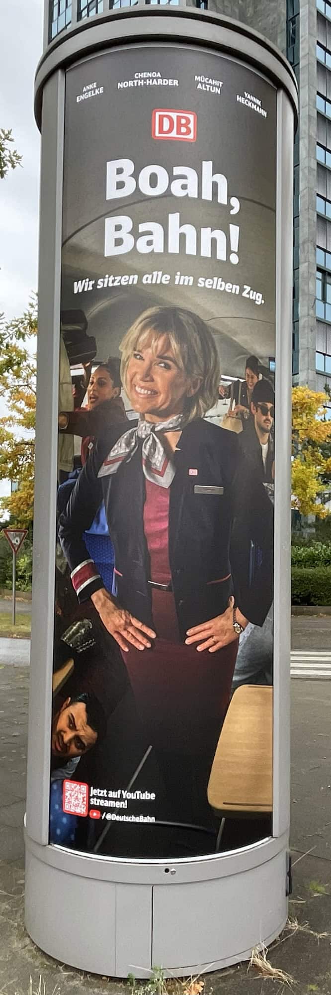 Litfaßsäule mit Deutsche Bahn Reklame mit Anke Engelke: Boah, Bahn! Wir sitzen alle im selben Zug.