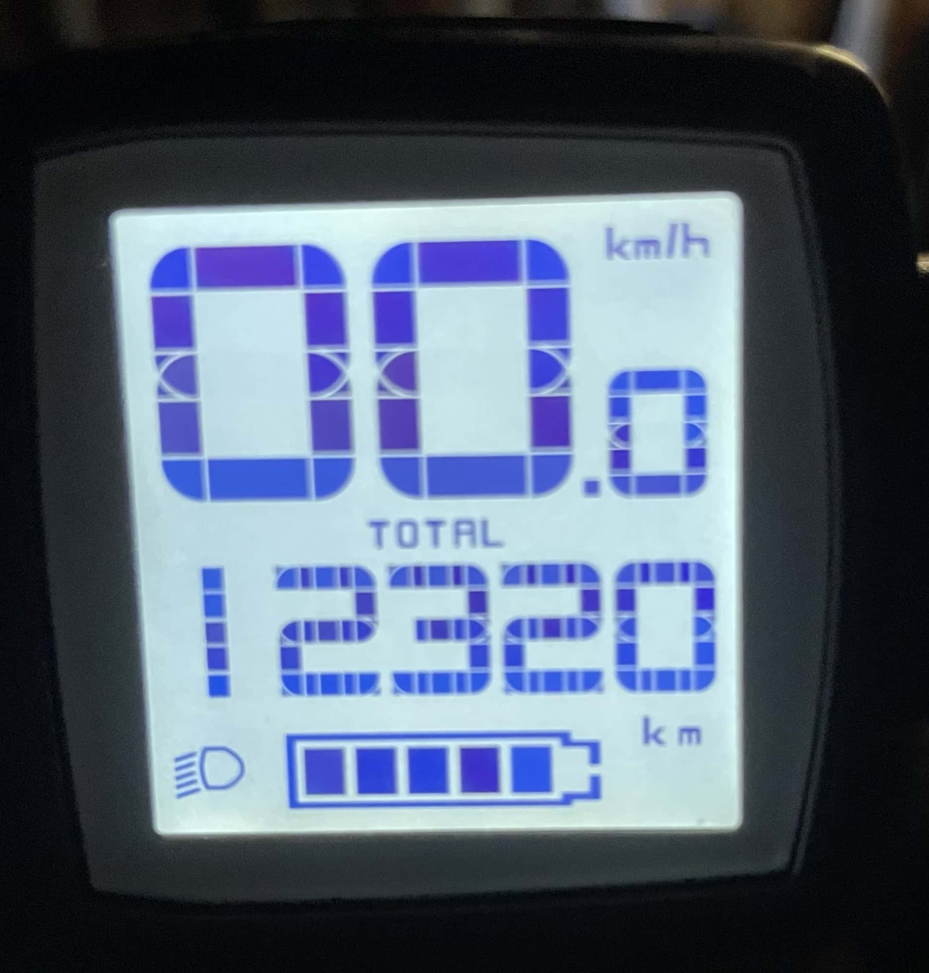 Im Dunklen helles Display des Fahrradtachos mit 12.320 km Fahrleistung.