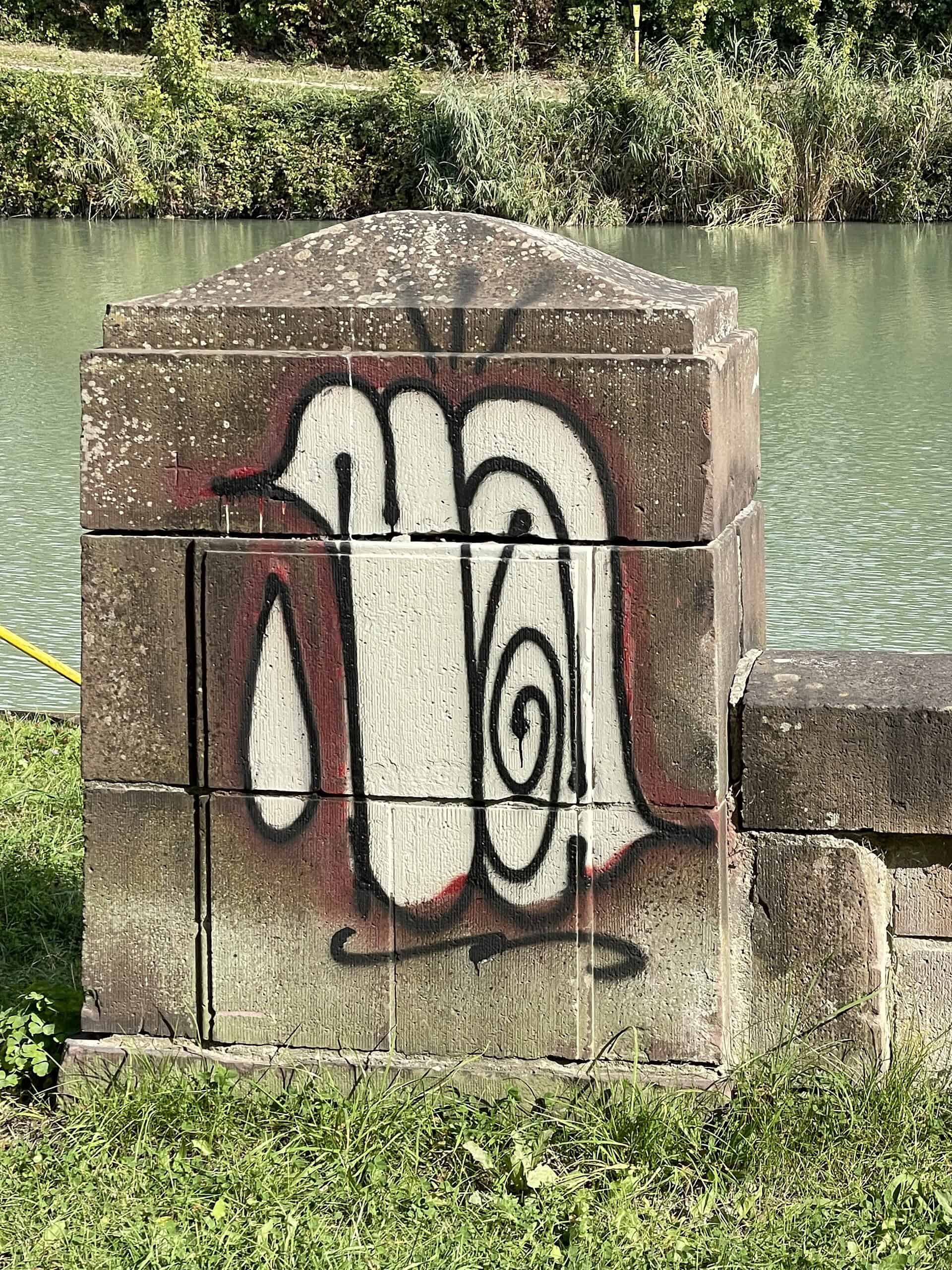 Graffiti auf Mauerbegrenzunhsstein am Mittellandkanal.